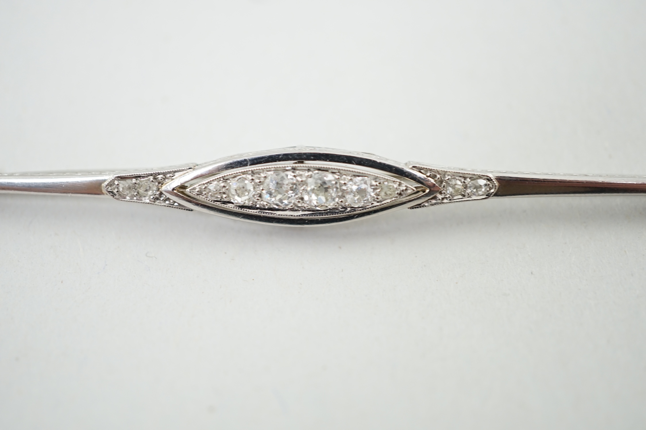 An early 20th century platinum? and diamond cluster set bar brooch